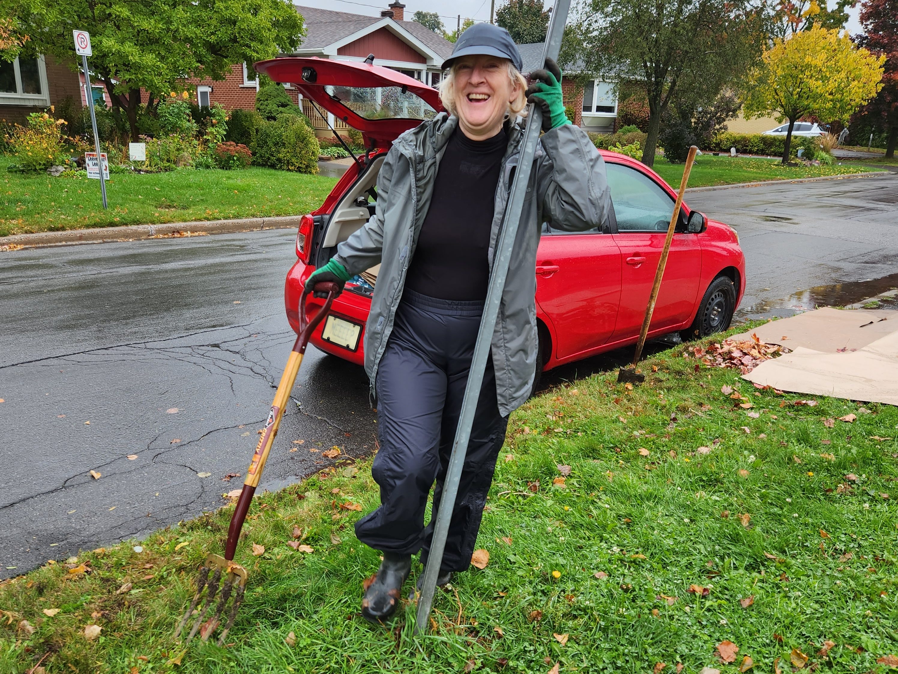 Pam smiling while holding a tool to break up gass